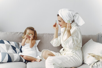 Obraz na płótnie Canvas Family at home. Woman in a bathrobe. Little girl in a towel.