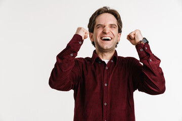 Fototapeta premium Handsome excited guy exclaiming and making winner gesture