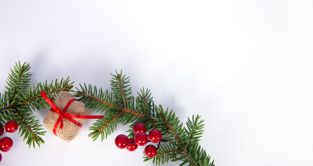 Christmas decoration with Christmas tree twigs and a gift on a white background. copy space