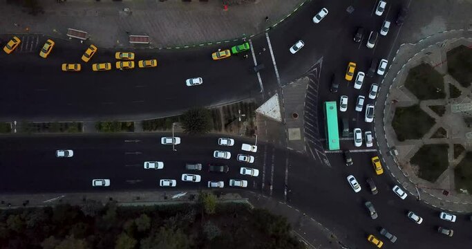 Aerial View Tehran Iran Big City Urban People Life Shahrak-e Gharb Sanat Square Cars Move Around Square Drives in Highway in Coronavirus Covid19 Yellow Taxi Cars in Station and Stop on Traffic Light