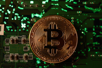 In this photo illustration, Bitcoin cryptocurrency commemorative coins on circuit board.