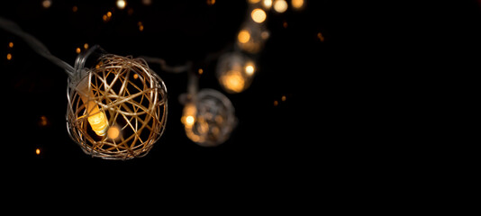 Festive illumination garland balls burn in the dark with a golden side and a place to advertise. Luxury lighting decoration