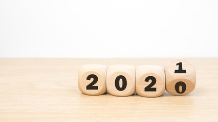 Message Year 2020 replaced by 2021 written on beach sand background. Good bye 2020 hello to 2021 happy New Year coming concept