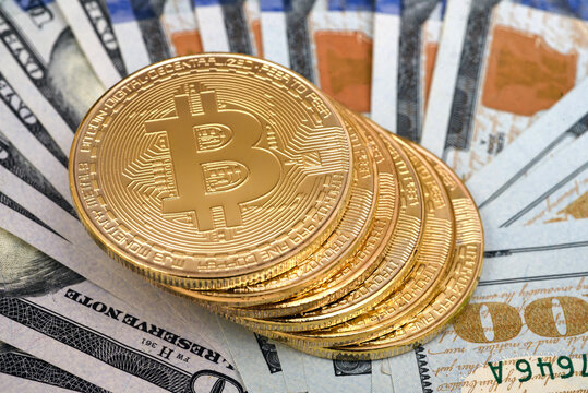 In this photo illustration, Bitcoin cryptocurrency commemorative coins on USA dollars.