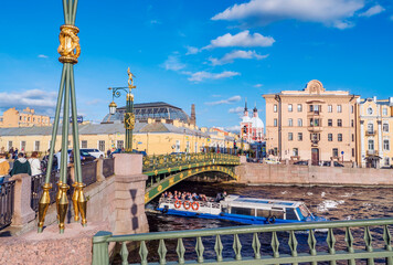 Saint-Petersburg. Fontanka river with a floating tourist boat . Panteleimon bridge. Russia.