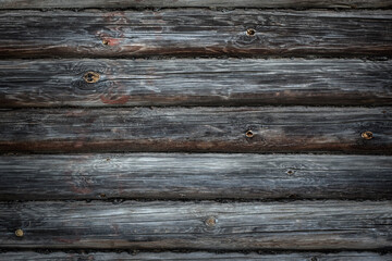 grey old wooden log wall as a rustic background