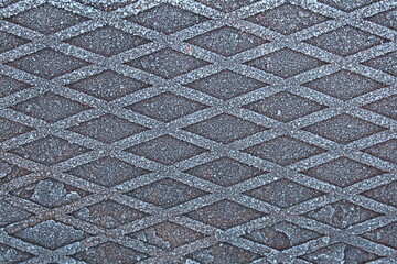 Texture iron surface with a pattern rhombus covered with frost in winter