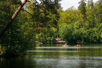 People float by boat on the lake in the famous Pushcha Vodytsya park in Kyiv, Ukraine. May 2011