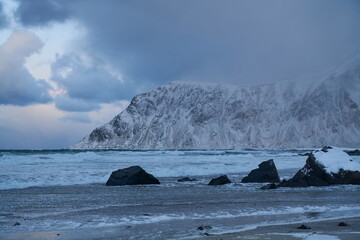 Fototapeta na wymiar norway coast in winter with snow bad cloudy weather