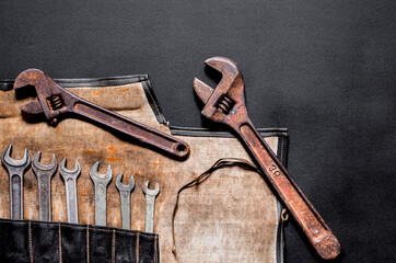 A set of old metal tools for repairs and business in a black case