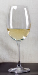 glass glass with white wine on a white faux fur background
