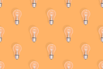 Lighting lamps seamless pattern. Background on the theme of light bulbs.