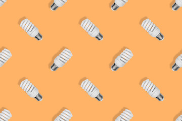 Lighting lamps seamless pattern. Background on the theme of light bulbs.