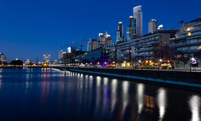 Fototapeta na wymiar Tourism in Buenos Aires. Puerto Madero at night. The most modern and luxurious neighborhood in Buenos Aires shows all its glamor at night. 
