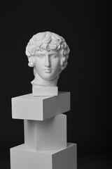 The plaster head of Antinous stands on rectangular figures. Visual aid for understanding light and shadow