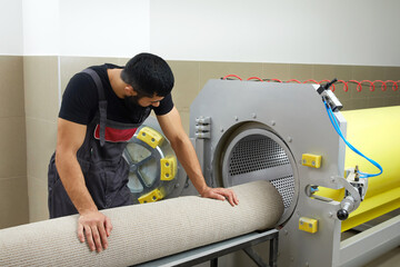 Man operating drying machine for carpet cleaning. Professional carpet cleaning service