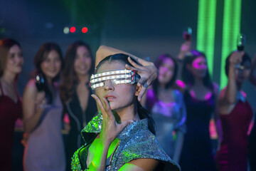 Event club dancing women with neon light . Party asian holidays celebrate nightlife. group of young girl happy dancing party hand holding a drink. lifestyle women young asian enjoyment nightclub.