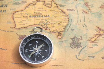 Fototapeta na wymiar Classic round compass on old vintage map depicting North America and the United States of America as symbol of tourism with compass, travel with compass and outdoor activities with compass