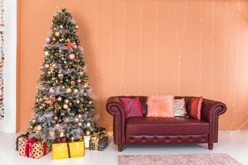 Beautiful Christmas tree in beige and gold colors in the interior. The concept of New Year and Christmas holidays