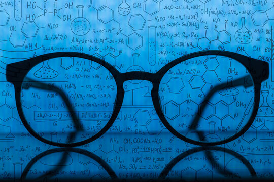Search by image
Close-up of glasses on open book in moody blue colour,Science theme. Retro education and scientific background. Scientific knowledge, formulas - Powered by Adobe