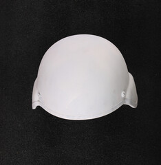 white tactical military helmet isolated on black background