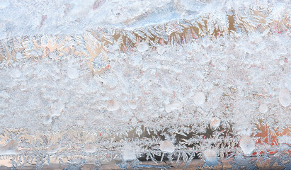Frost patterns on the window, hoarfrost background. Frosty Christmas pattern on the winter window glass. Copy space, natural texture, macro