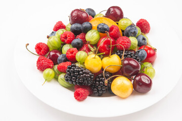 Fototapeta na wymiar Assorted fresh different berries on a white plate. useful vitamin healthy food fruit. healthy vegetable breakfast
