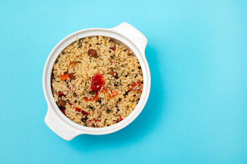 tabbouleh on small white bowl on blue background