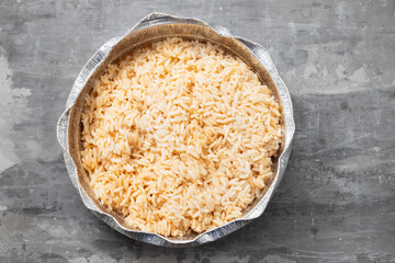 boiled rice in box take away on ceramic background