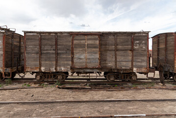 Old and rusty wooden train car abandoned on a railway track. Bolivia