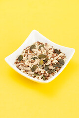 assorted seeds in the small white bowl