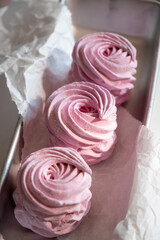 Pink strawberry homemade zephyr or marshmallow in a rectangular oleum plate. side view, close-up, selective focus