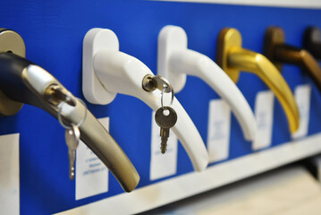 Concept of protecting the child from falling out of the window. Handle with a lock on the window. Samples of different colors.