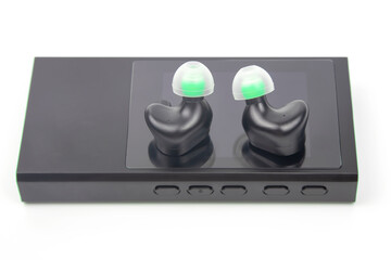 In-ear headphones for Hi-Fi music player. Audio sound and modern equipment for music lovers and...