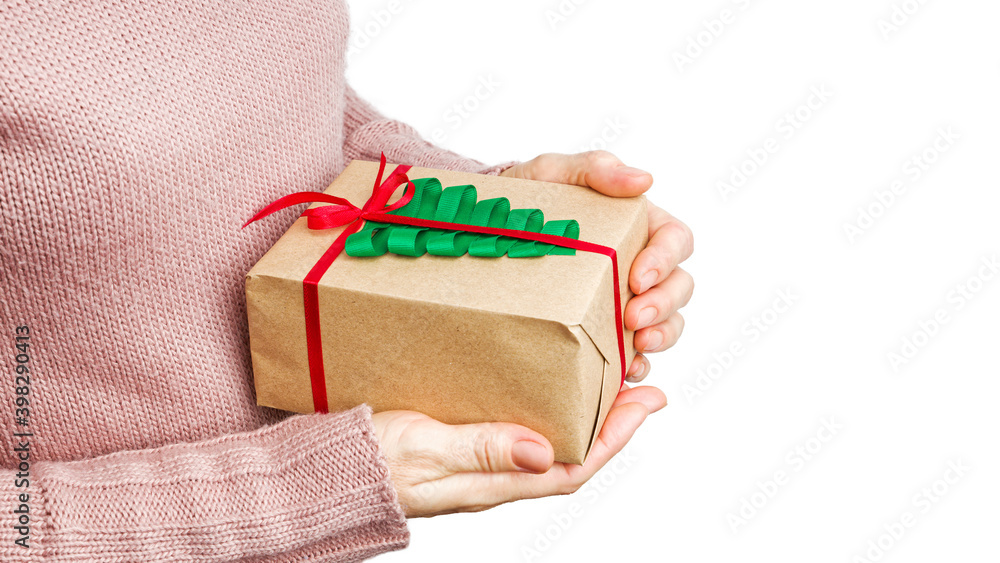 Wall mural female hands holding gift box wrapped in kraft paper and tied with twine isolated on white backgroun