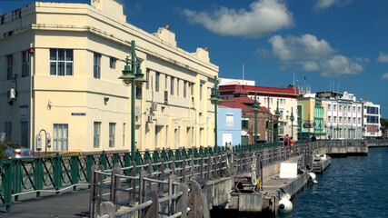 Famous Boardwalk with distant walking tourists and locals  on a nice sunny afternoon in Bridgetown, Barbados. - obrazy, fototapety, plakaty