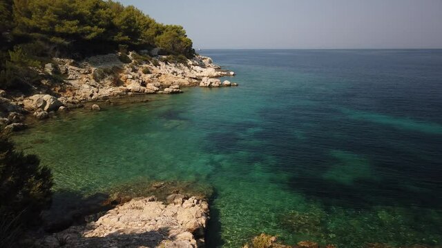 Panning view of clear waters and amazing blue waters of Svitnja beach on the island of Vis in Croatia