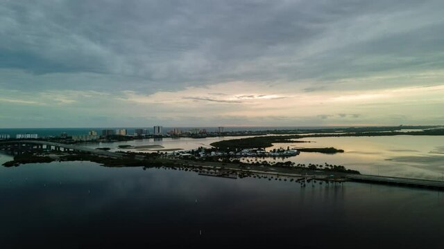 Aerial sunrise hyperlapse at river with ocean in the back, Daytona Beach, Florida