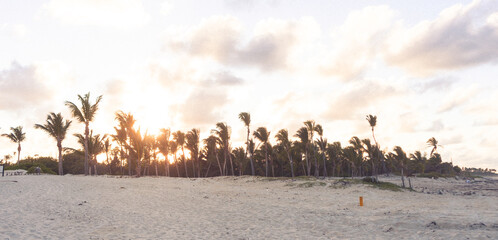 Gorgeous tropical beach background with sun flares at sunset in the Dominican Republic.