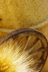Ears of golden wheat kissed by the sun and in the background an old wagon wheel