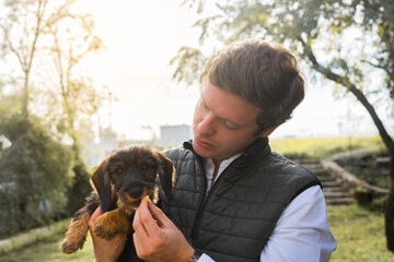 young man gives food to his new puppy