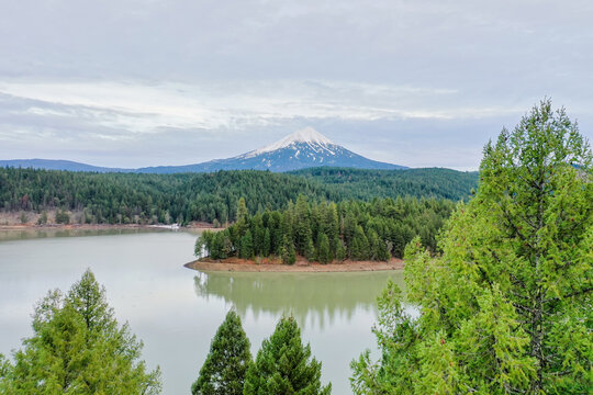 Peaceful lake in the forest with a mountain as background © Christian