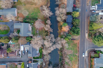 Above view of a peaceful river in the middle of a neighborhood