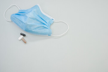Medical mask with capsules on gray background - the concept of new normal