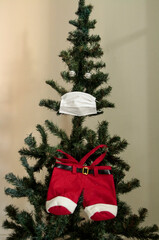 Christmas tree with face mask. Christmas decoration. Coronavirus pandemic Covit-19.
