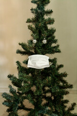 Christmas tree with face mask. Christmas decoration. Coronavirus pandemic Covit-19.