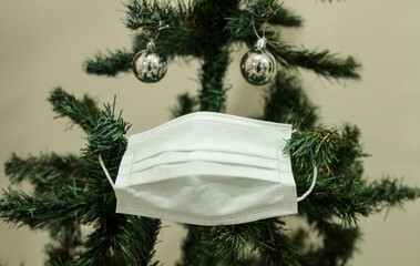 Christmas tree with face mask. Christmas decoration. Coronavirus pandemic Covit-19.