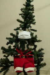 Christmas tree with face mask. Christmas decoration. Coronavirus pandemic Covit-19.