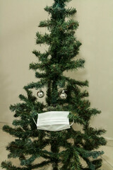 Christmas tree with face mask. Christmas decoration. Coronavirus pandemic Covit-19.