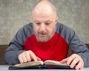 happy bearded man studies the Bible. religion and Christianity